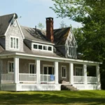 white and brown wooden house near green trees during daytime
